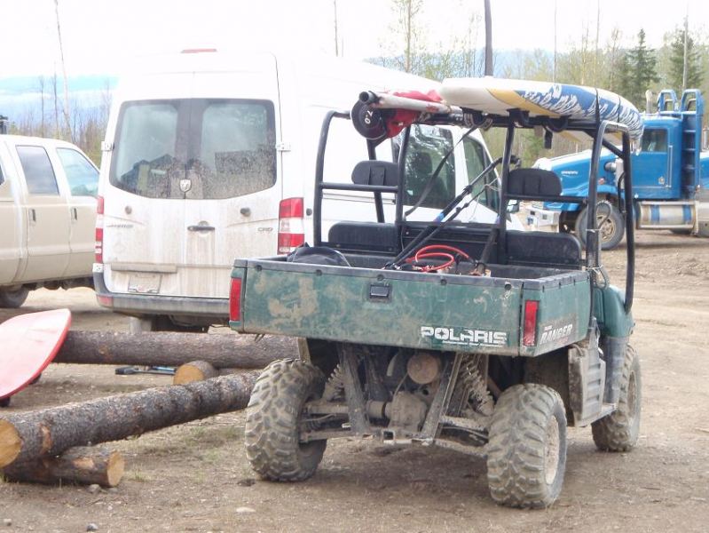 Ranger in camp, with Kona longboard on the rack.
